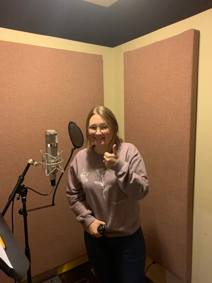 Skye Peterson standing beside a microphone in the vocal booth.