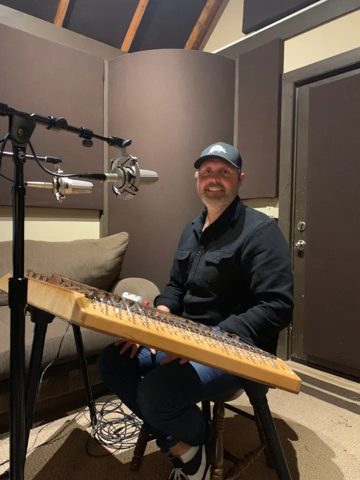 Gabe Scott seated at an instrument in the recording studio.