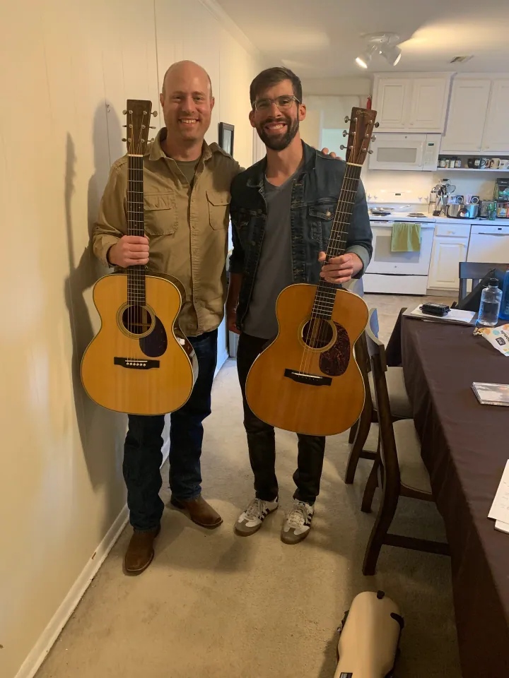 Sam and Nate holding their acoustic guitars.