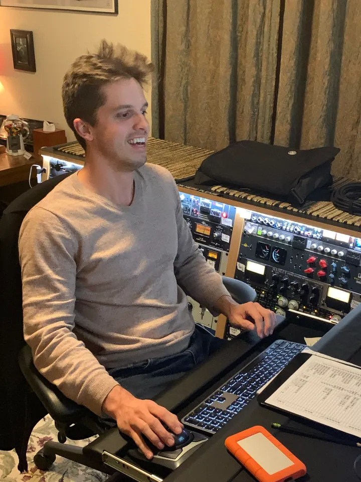 Evan Redwine seated at the studio mixing desk.
